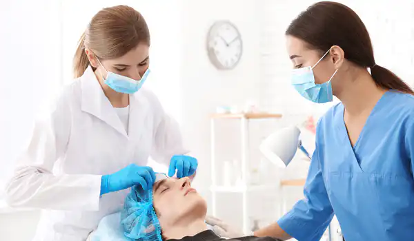 Professional beautician teaching trainee in salon. Apprenticeship concept